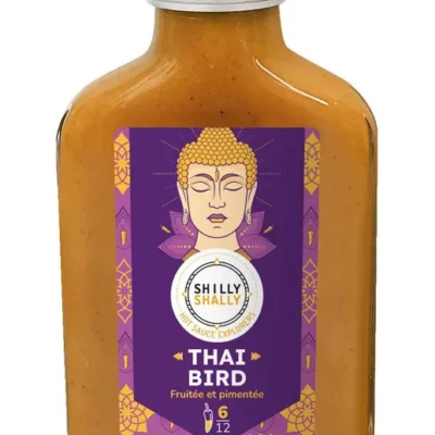 Bouteille de sauce piquante Shilly Shally Thai Bird, 100ml, au goût fruité et pimenté, étiquette violette avec motif exotique.